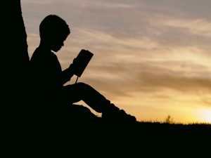 Hand holding Quran with divine light